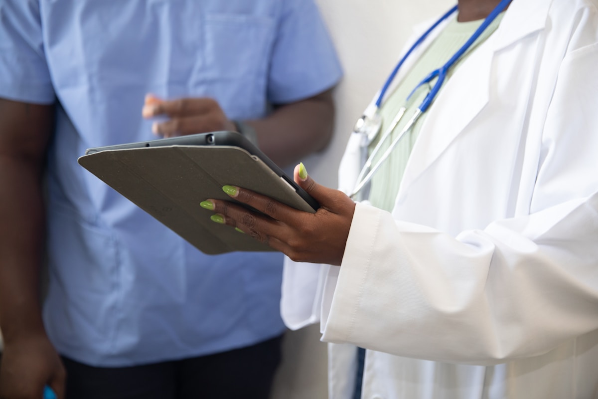 a doctor showing a patient something on the tablet